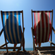 Two people relaxing on the beach during a hot summer day.